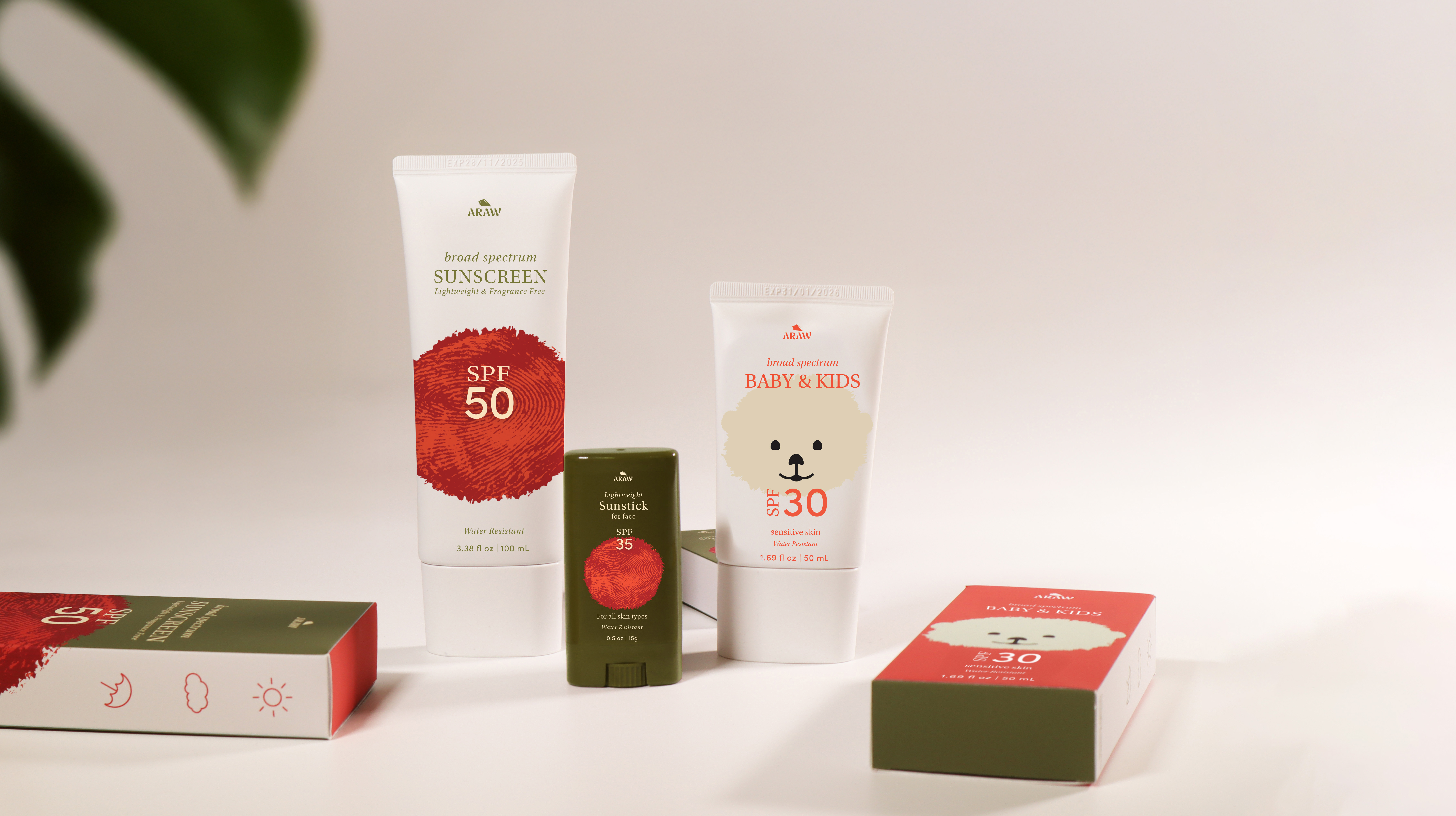 Image of three of the Araw sunscreen for adults, kids & baby's, and the facestick